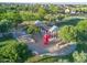 Aerial view of a playground with slides, benches, and shade structures located in a community park at 15289 W Valentine St, Surprise, AZ 85379