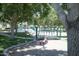 Community playground featuring multiple play structures, a bridge, and shaded seating areas at 15289 W Valentine St, Surprise, AZ 85379