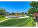 Community playground with slides and swings surrounded by lush landscaping, perfect for recreation at 15289 W Valentine St, Surprise, AZ 85379