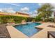 Inviting backyard pool features elegant landscaping and water features, perfect for relaxation at 15289 W Valentine St, Surprise, AZ 85379