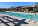 Lap pool with comfortable lounge chairs under a shaded structure, ideal for exercise and outdoor enjoyment at 15289 W Valentine St, Surprise, AZ 85379