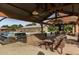 Outdoor poolside patio featuring a large barbecue grill and a picnic table at 15289 W Valentine St, Surprise, AZ 85379