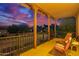 Covered porch with views of the neighborhood at dusk at 15289 W Valentine St, Surprise, AZ 85379