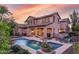 Stunning home with solar panels, a backyard pool, and patio area at sunset at 15289 W Valentine St, Surprise, AZ 85379