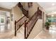 Carpeted staircase featuring stained wood handrails at 15289 W Valentine St, Surprise, AZ 85379