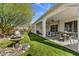 Inviting covered patio features a water fountain, seating, and outdoor dining, perfect for relaxing and entertaining at 16987 W Princeton Ave, Goodyear, AZ 85395