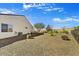 Spacious backyard featuring low-maintenance gravel landscaping, small turf area, and a charming bench at 16987 W Princeton Ave, Goodyear, AZ 85395