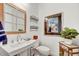 Cozy half-bathroom with a unique mirror, modern sink, and decorative wall art at 16987 W Princeton Ave, Goodyear, AZ 85395