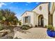 Inviting home entrance with brick walkway and landscaped planters leading to the front door at 16987 W Princeton Ave, Goodyear, AZ 85395