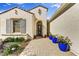 Inviting home entrance with brick walkway and potted plants leading to the front door at 16987 W Princeton Ave, Goodyear, AZ 85395