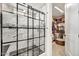 Modern shower with a grid-style glass door and a view into a walk-in closet at 16987 W Princeton Ave, Goodyear, AZ 85395