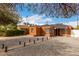 Beautiful brick home featuring a unique rock yard, charming pathway, and modern architectural details at 1810 N 12Th St, Phoenix, AZ 85006