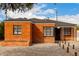 Quaint brick home with a dark roof, black trim, with rock front yard landscaping at 1810 N 12Th St, Phoenix, AZ 85006