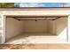 Interior view of an attached garage showing the painted floor and a door leading to the house at 1810 N 12Th St, Phoenix, AZ 85006