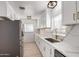 Bright kitchen with white cabinets, quartz countertops, stainless steel appliances, and modern faucet at 1810 N 12Th St, Phoenix, AZ 85006