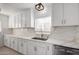 Bright, updated kitchen with white cabinetry, quartz countertops, modern faucet, and stainless steel appliances at 1810 N 12Th St, Phoenix, AZ 85006