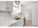 Remodeled kitchen with white cabinets, quartz countertops, stainless steel appliances, and modern gold faucet at 1810 N 12Th St, Phoenix, AZ 85006