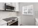 Bright kitchen featuring quartz countertops, stainless steel appliances, and white cabinets at 1810 N 12Th St, Phoenix, AZ 85006