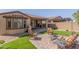 Charming backyard featuring a patio, artificial grass, and outdoor furniture for relaxation at 18182 W Glenhaven Dr, Goodyear, AZ 85338