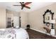 This bedroom has wood-look floors, stylish decor, and en-suite access at 18182 W Glenhaven Dr, Goodyear, AZ 85338