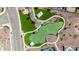 High angle view of the park's green space, landscaping, and walking paths showcasing community amenities at 18182 W Glenhaven Dr, Goodyear, AZ 85338