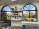 Bright crafts room featuring large windows and shelving to display paintings and other artwork at 18182 W Glenhaven Dr, Goodyear, AZ 85338