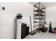 Garage storage area with shelving, cleaning supplies, and a water softener system at 18182 W Glenhaven Dr, Goodyear, AZ 85338