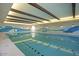 Bright indoor pool with a modern mural, perfect for year-round swimming and recreation at 18182 W Glenhaven Dr, Goodyear, AZ 85338