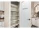 A well-organized pantry with frosted door offers ample storage space at 18182 W Glenhaven Dr, Goodyear, AZ 85338