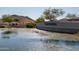 Cantamia community welcome sign by a small pond with natural desert landscaping in the background at 18182 W Glenhaven Dr, Goodyear, AZ 85338