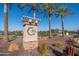 Community welcome sign with palm trees and manicured landscaping providing an inviting entrance at 18182 W Glenhaven Dr, Goodyear, AZ 85338