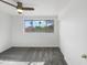 Well-lit bedroom featuring plush carpeting, a ceiling fan, and a large window with a picturesque view at 1940 W Oriole Way, Chandler, AZ 85286