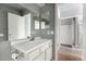 Bathroom featuring a vanity sink with mirror, toilet paper holder, and entrance to bedroom at 2035 S Elm St # 218, Tempe, AZ 85282