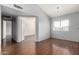 A bedroom featuring hardwood floors, a window, and light blue walls at 2035 S Elm St # 218, Tempe, AZ 85282