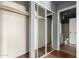 This is a closet with mirrored sliding doors and a view to the adjacent bathroom at 2035 S Elm St # 218, Tempe, AZ 85282