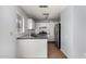 Bright kitchen with stainless steel refrigerator, white cabinets and subway tile backsplash at 2035 S Elm St # 218, Tempe, AZ 85282