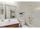 A bathroom features neutral walls, wood cabinets, and a shower over tub at 20512 N 260Th Ln, Buckeye, AZ 85396