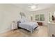 A bedroom features a bed, ceiling fan, bedside tables, and a window with shutters at 20512 N 260Th Ln, Buckeye, AZ 85396