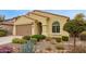 Attractive house featuring a well-manicured front yard with native plants and a bench at 20512 N 260Th Ln, Buckeye, AZ 85396