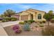 Landscaped front yard with desert plants and a bench under an arched window at 20512 N 260Th Ln, Buckeye, AZ 85396