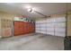 Spacious garage with built-in cabinets for ample storage solutions and an automatic garage door at 20512 N 260Th Ln, Buckeye, AZ 85396