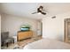 Bright bedroom featuring tile floors, ceiling fan, and a stylish dresser with a mounted TV at 25515 N Forest N Rd # 2, Rio Verde, AZ 85263