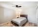 Cozy bedroom with ceiling fan, wood-look floors and comfortable bed at 25515 N Forest N Rd # 2, Rio Verde, AZ 85263