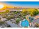 Home with inviting pool and lush desert landscaping with picturesque mountain views at sunset at 26560 N 115Th St, Scottsdale, AZ 85255