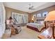 Cozy bedroom featuring plantation shutters, neutral walls, and a comfortable sitting area at 26560 N 115Th St, Scottsdale, AZ 85255