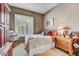 Cozy bedroom featuring plantation shutters, a bedside table and lamps at 26560 N 115Th St, Scottsdale, AZ 85255