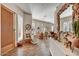 Inviting foyer with wood floors, elegant decor, and plenty of natural light streaming through plantation-shuttered windows at 26560 N 115Th St, Scottsdale, AZ 85255