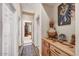 Hallway featuring wood floors, neutral walls, and interesting decor on top of a credenza at 26560 N 115Th St, Scottsdale, AZ 85255