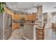 Kitchen featuring light wood cabinets, granite countertops, stainless steel appliances, and breakfast bar, great for a homebuyer at 26560 N 115Th St, Scottsdale, AZ 85255