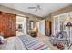 Spacious main bedroom with barn door to closet, ensuite bath, and charming decor at 26560 N 115Th St, Scottsdale, AZ 85255